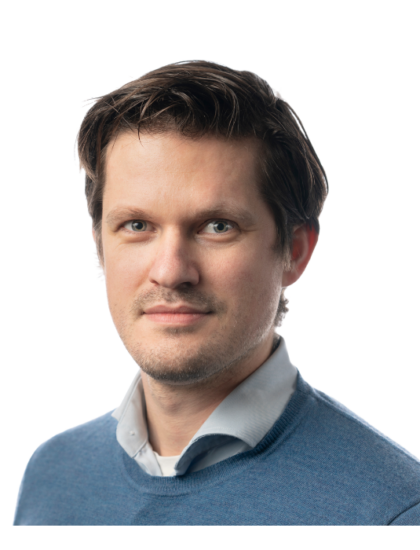 Steven, wearing a blue sweater, looking directly at the camera with a neutral expression.