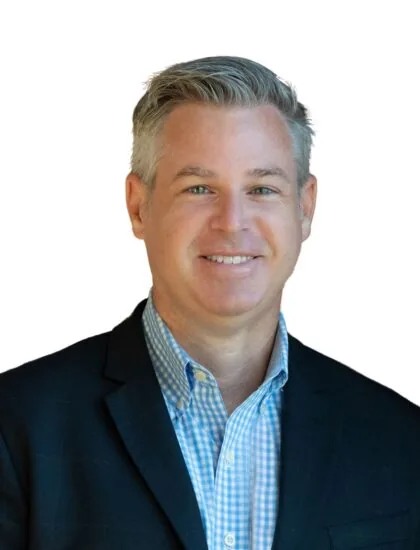 Andrew Brodeur smiling in a suit jacket