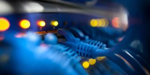 Closeup Of A Server Network Panel with Lights and Cables